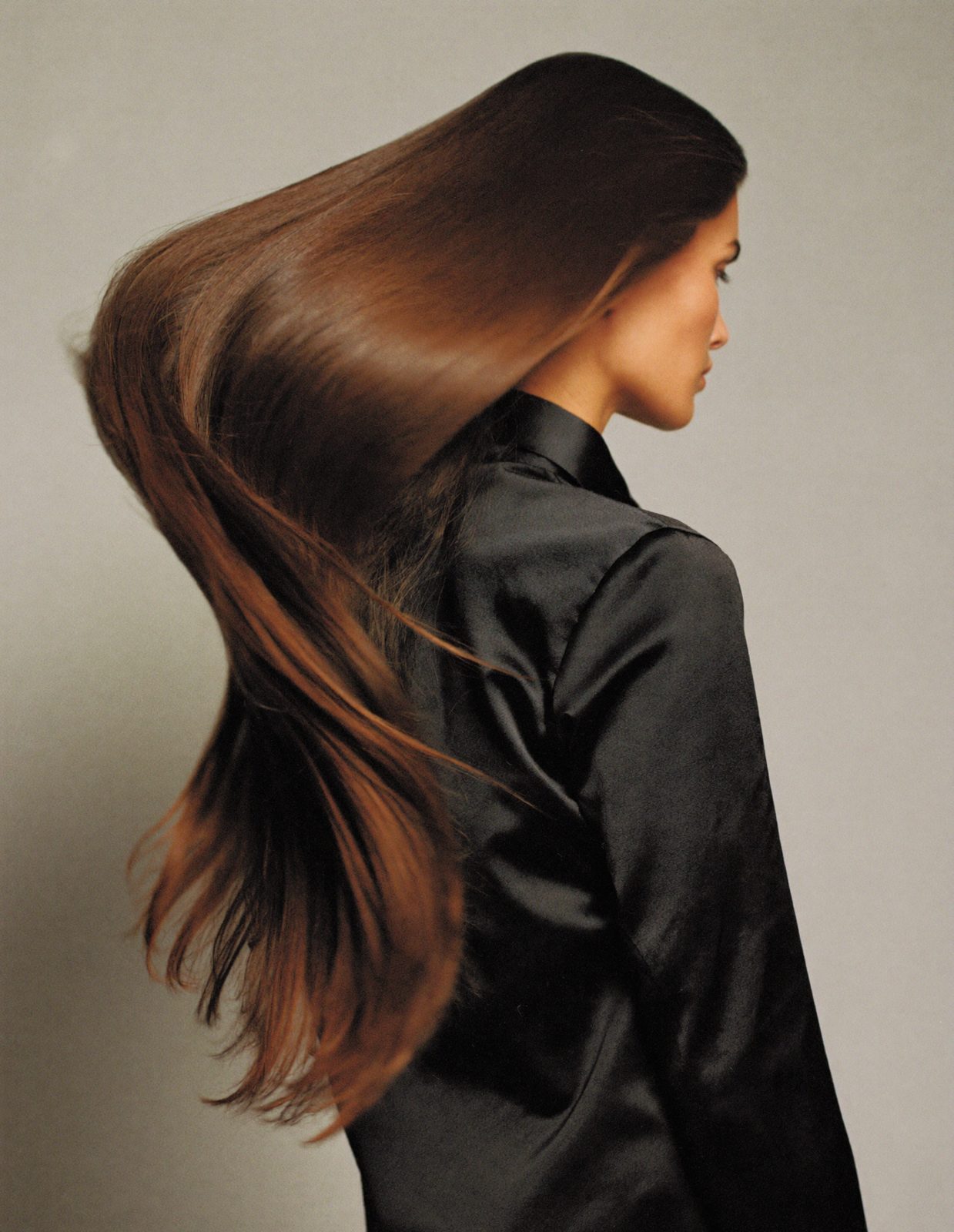 A client turning her head, long glossy brunette hair swinging
